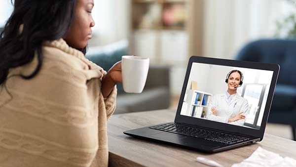 sick lady talking with doctor online